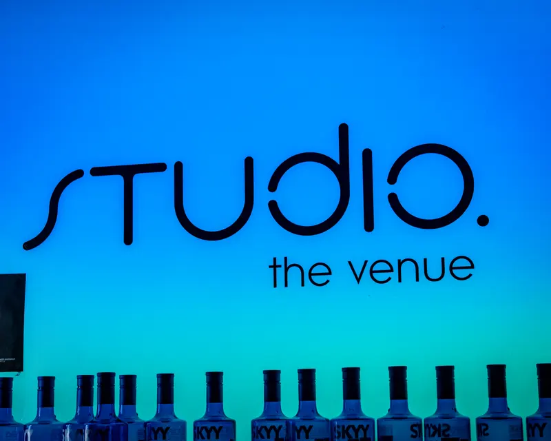 Studio the venue signage above bottles behind the bar