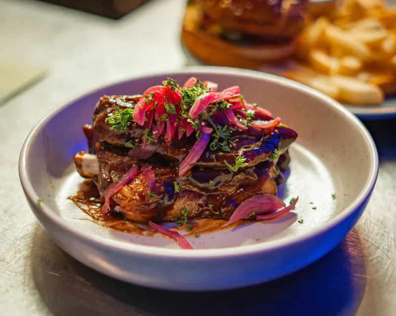 Plated restaurant dish photographed under warm service lighting