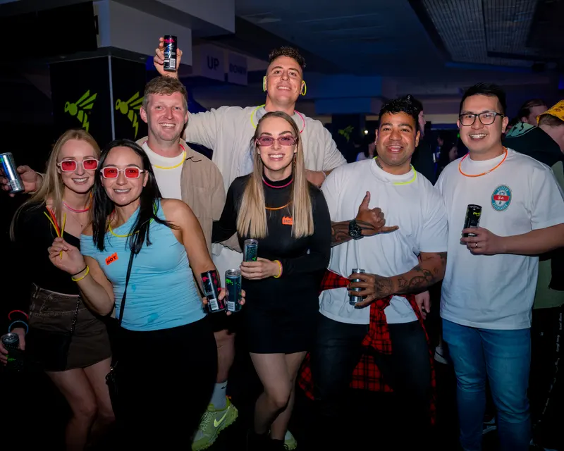 Group of friends wearing colourful glasses and glow necklaces