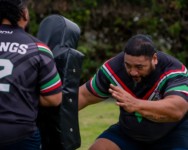 Rugby league player bracing for contact with an opponent